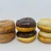 A half-dozen donuts, with two each of Churro, Chocolate Cream-filled, and Maple Glazed Donuts