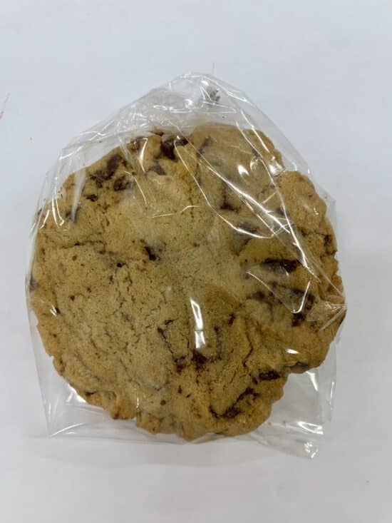 A large size chocolate chip cookie in a cello bag